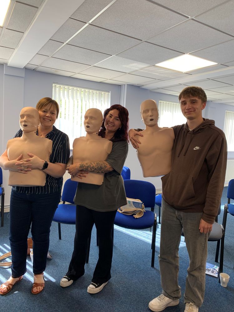 Delegates with CPR training manikins during an on-site first aid course